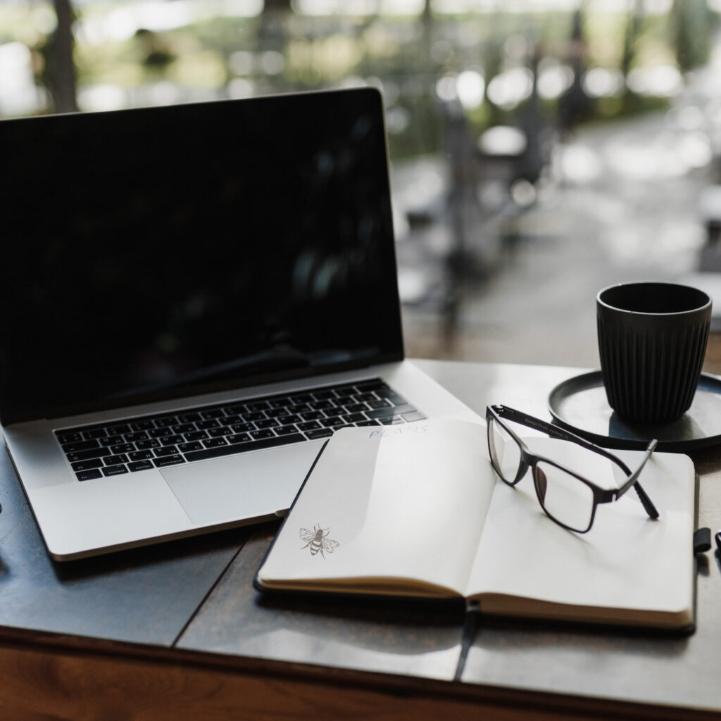 Reviewing an AI policy at a desk with a laptop and notebook